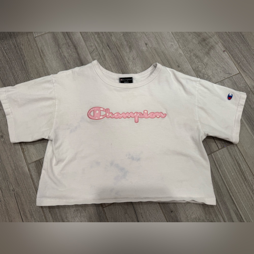Cropped White Champion Top with Pink embroidered logo that has daisies on it